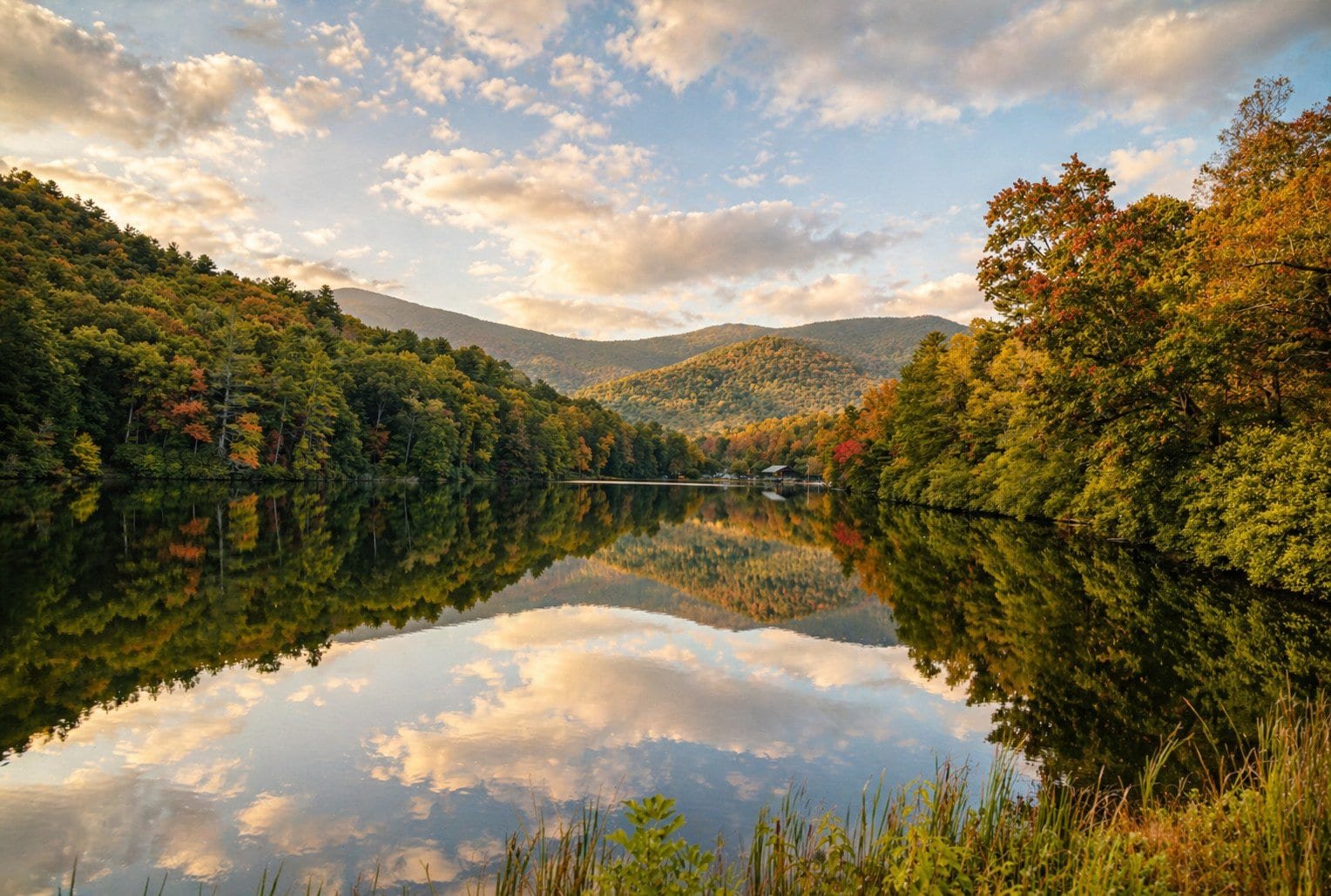 Scenic view of Blairsville, GA lake surrounded by colorful autumn trees.