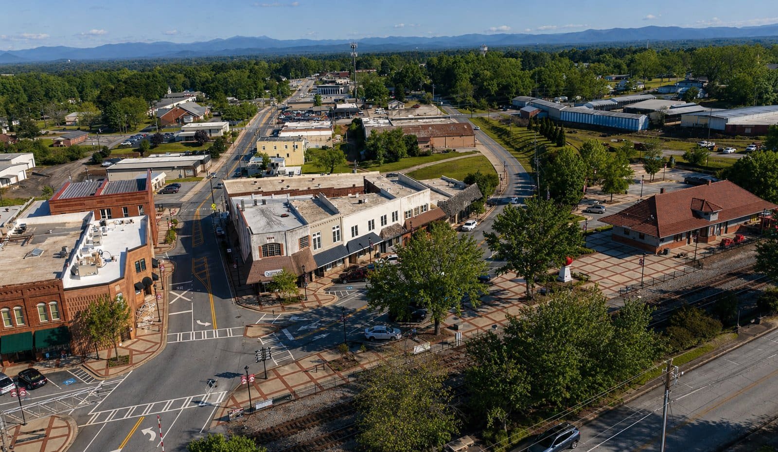 Aerial view of downtown Cornelia, GA showcasing local businesses, streets, and green spaces. Perfect.