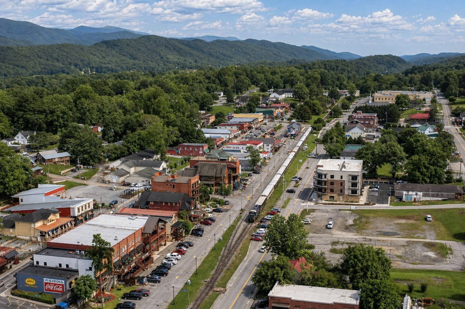 Aerial view of Blue Ridge, GA showcasing downtown area, streets, and surrounding mountains.