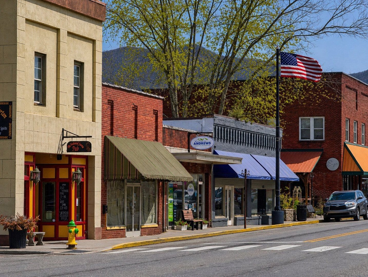 Historic downtown buildings in Andrews, NC, showcasing local businesses and scenic mountain views.